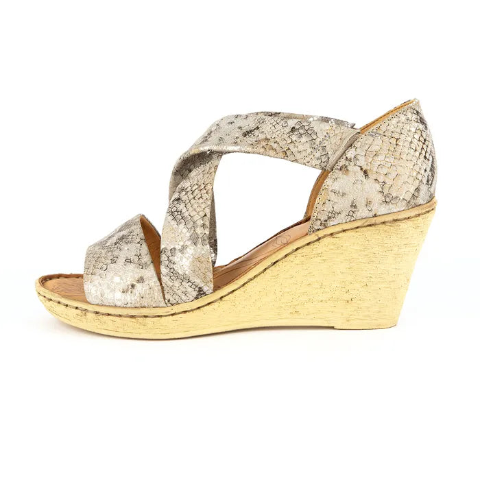 Wedge sandal with snake print upper and wedge sole on a white background