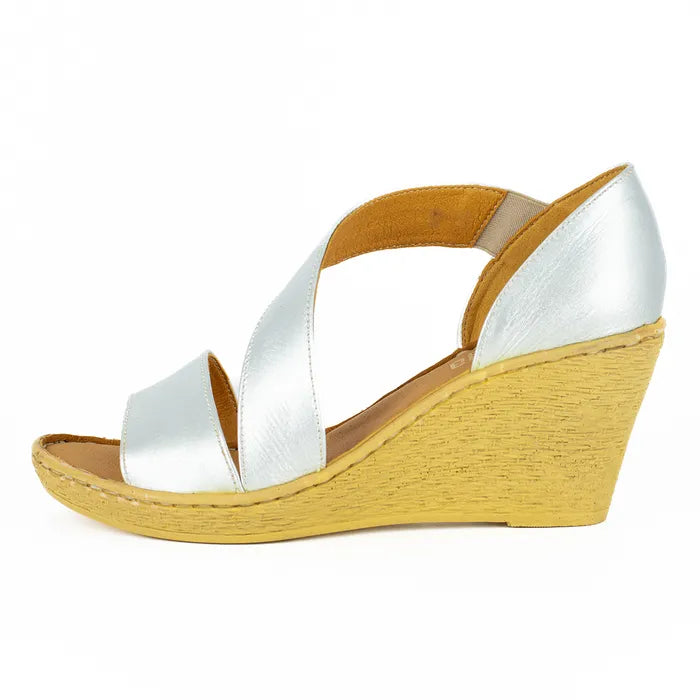 Silver sandal on a wedge sole on a white background