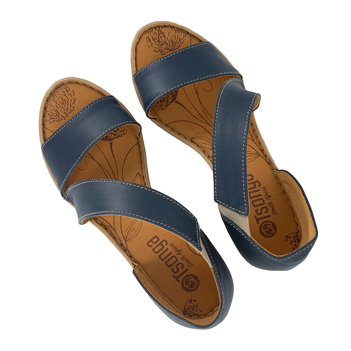 Pair of blue sandals with brown soles on a white background