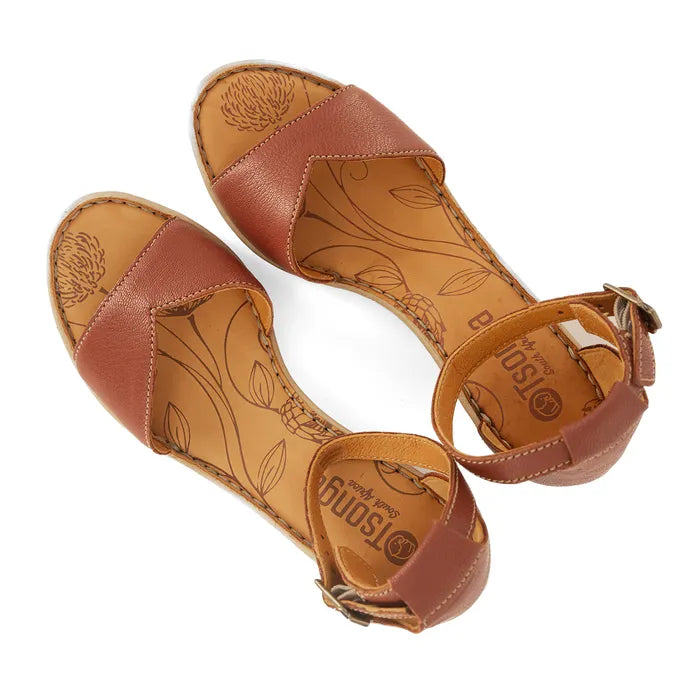 Pair of brown sandals with floral patterns on a white background