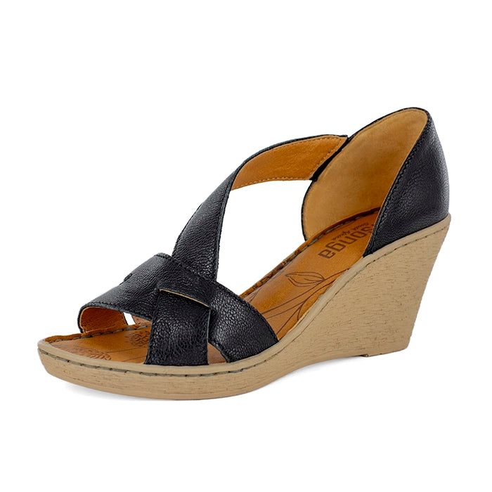 Black wedge sandal with tan sole on a white background