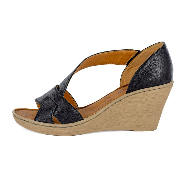 Black wedge sandal with a tan sole on a white background