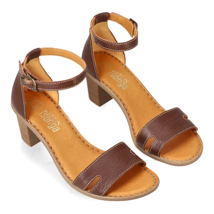 A pair of women's brown leather block-heel sandals with ankle straps and cutout details, displayed on a clean white background.