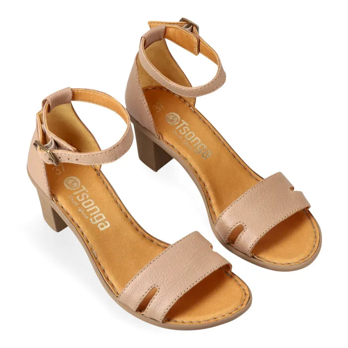 Pair of beige sandals with beige heels on a white background