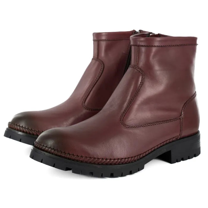 Pair of maroon leather boots on a white background