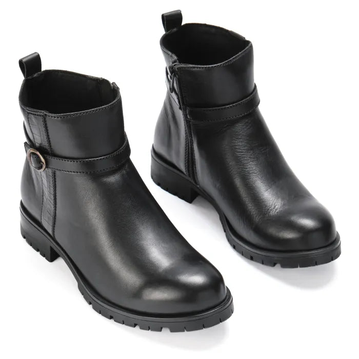 Pair of black leather ankle boots on a white background