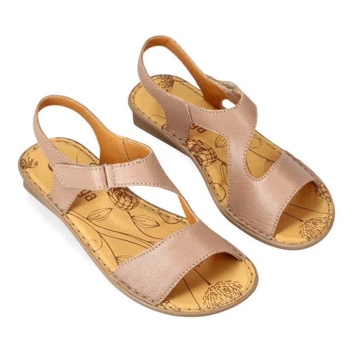 Pair of beige sandals with floral patterns on a white background