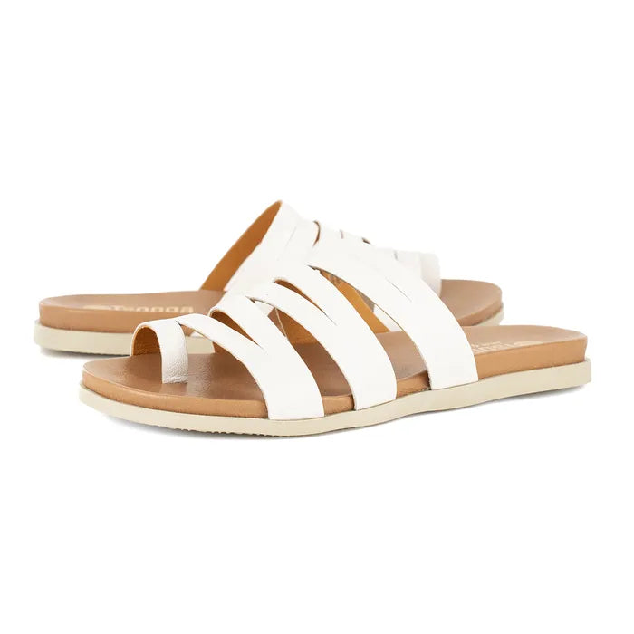Pair of white sandals with brown soles on a white background