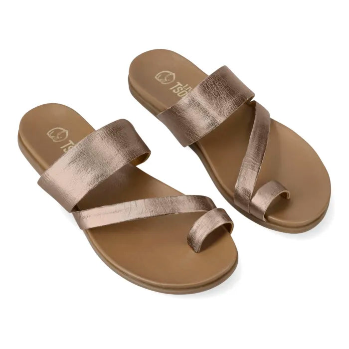 A pair of metallic rose gold flat slide sandals with criss-cross straps, shown on a clean white background.