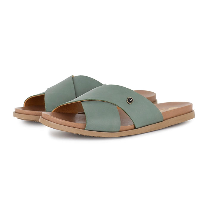 Pair of green sandals with tan soles on a white background
