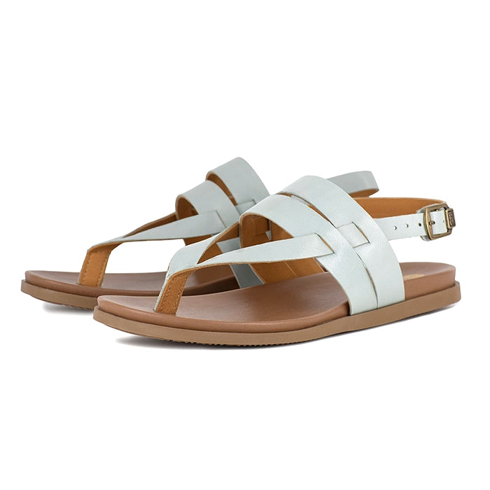 Pale blue sandals with brown soles on a white background