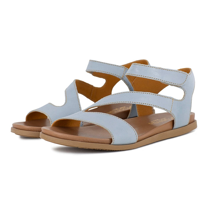 Light blue sandals with brown soles on a white background