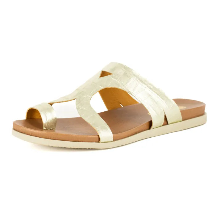 Gold sandal with a brown sole on a white background