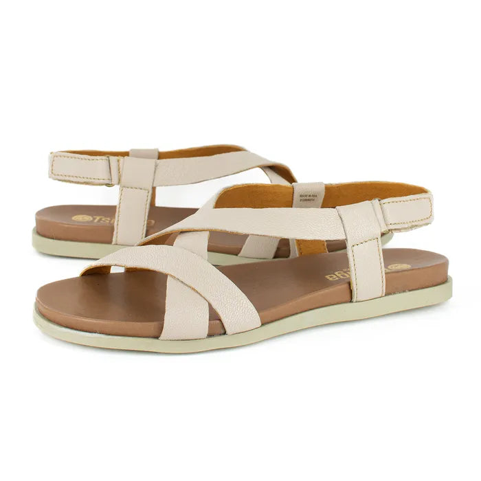 Pair of beige sandals with brown soles on a white background