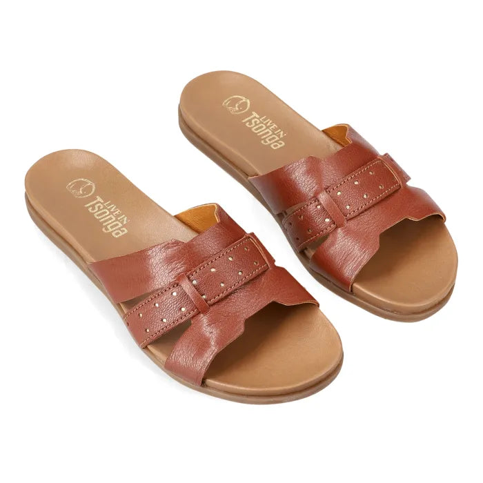 A pair of women's slide sandals with brown leather straps and a tan footbed, shown on a plain white background. The brand name 'Tsonga' is visible on the insole.