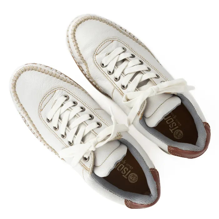 White sneakers with brown soles on a white background