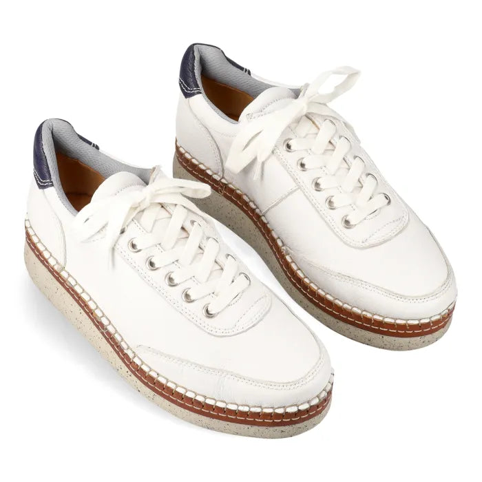 White sneakers with wedge soles on a white background