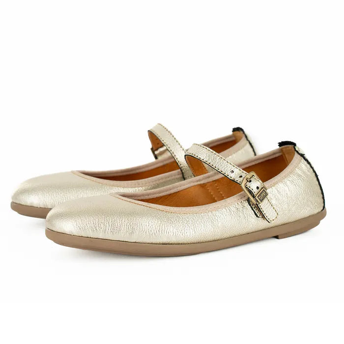 Pair of gold metallic flats with a strap on a white background
