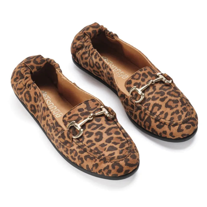 Pair of leopard print loafers with gold buckles on a white background