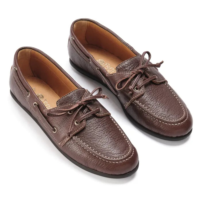Pair of brown leather boat shoes on a white background