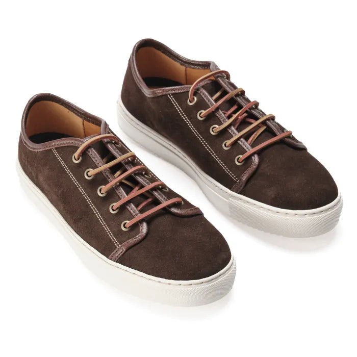Pair of brown suede sneakers with white soles on a white background