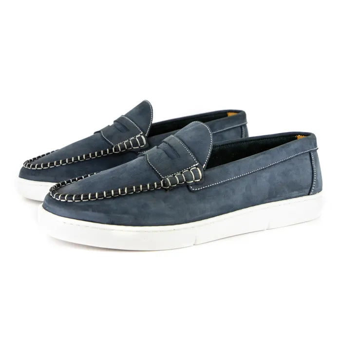 Pair of blue loafers with white soles on a white background