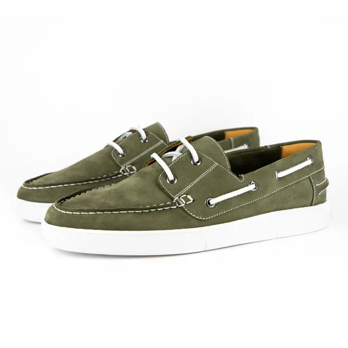 Pair of green suede boat shoes with white soles on a white background
