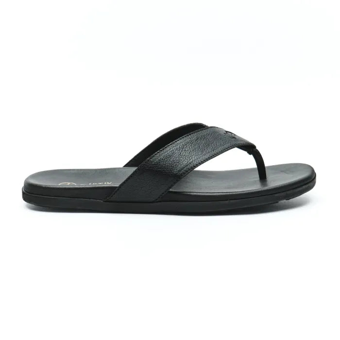 A single black flip-flop sandal shown in a side profile view against a clean white background. The sandal features a textured, ribbed strap with a small metallic circular logo and a thick, contoured black sole.