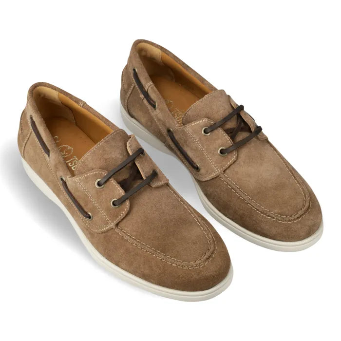 A pair of men's casual boat shoes in taupe brown suede, featuring dark brown laces, contrast stitching, and white rubber soles, shown on a white background.