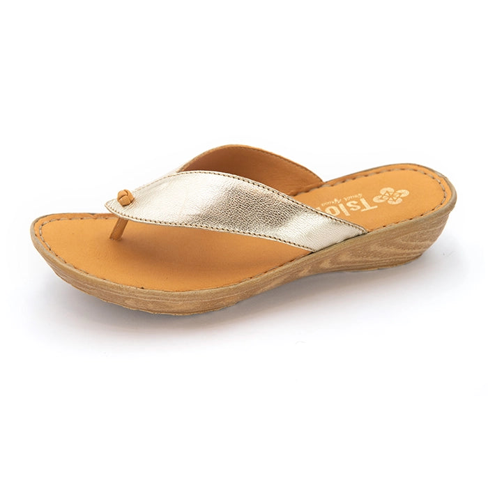 A single women's wedge thong sandal by Tsonga Shoes, featuring a metallic gold strap and a tan leather footbed on a light wood-textured wedge heel, shown against a plain white background.