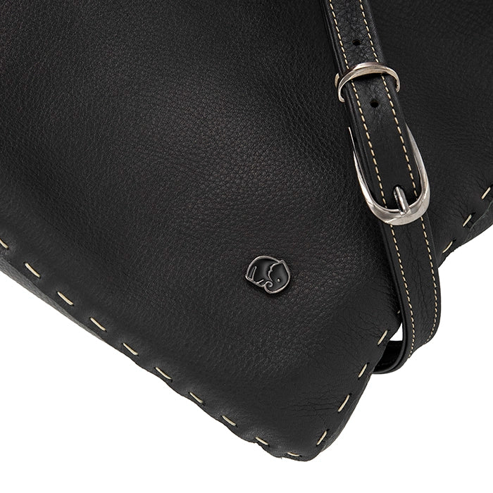 Close-up of a black leather bag with a visible brand logo on a white background