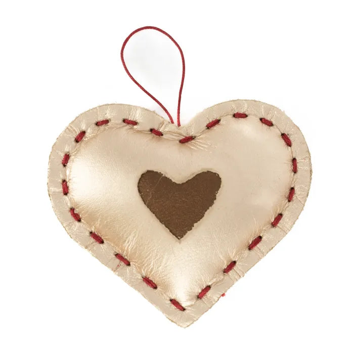 Heart-shaped leather ornament with red stitching on a white background