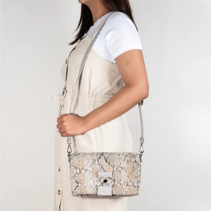 Person holding a patterned handbag.