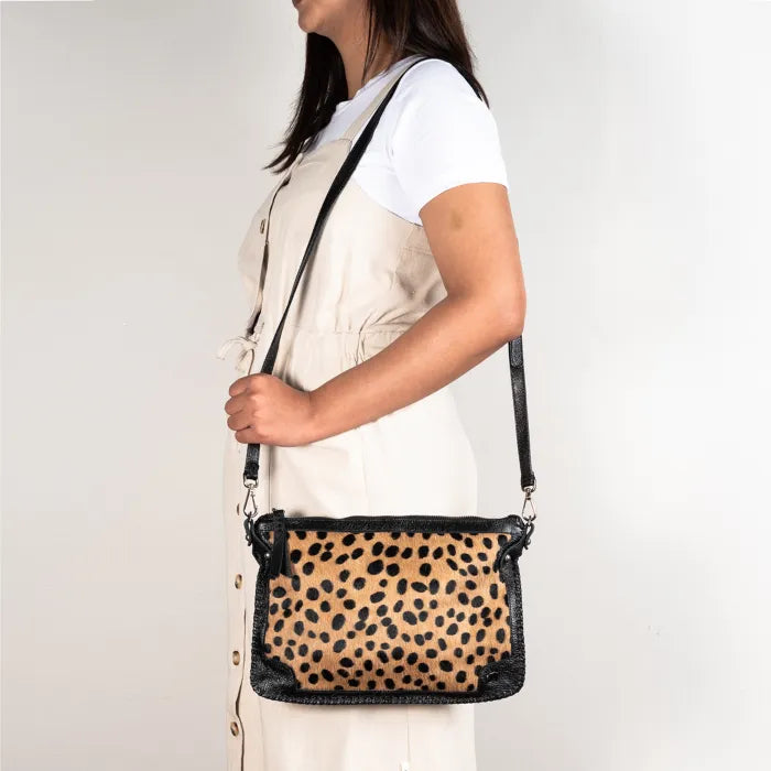 Person wearing a Spotted print crossbody bag on a plain background