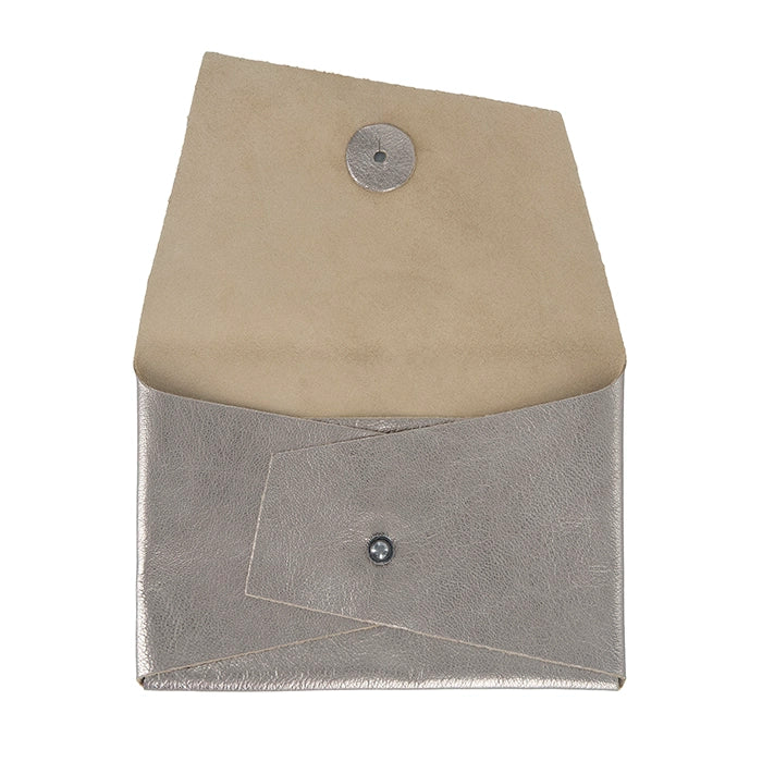 Open metallic silver leather clutch purse with flap lifted, showing beige leather interior and a front buttoned pocket.