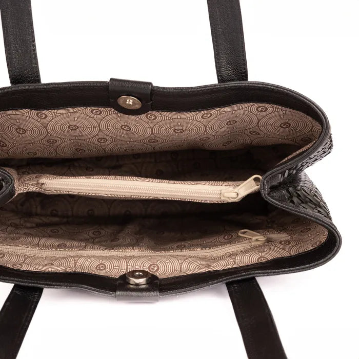 Black handbag with patterned interior on a white background