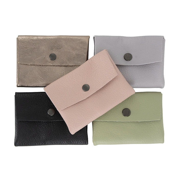 Five small leather pouches in different colours on a white background