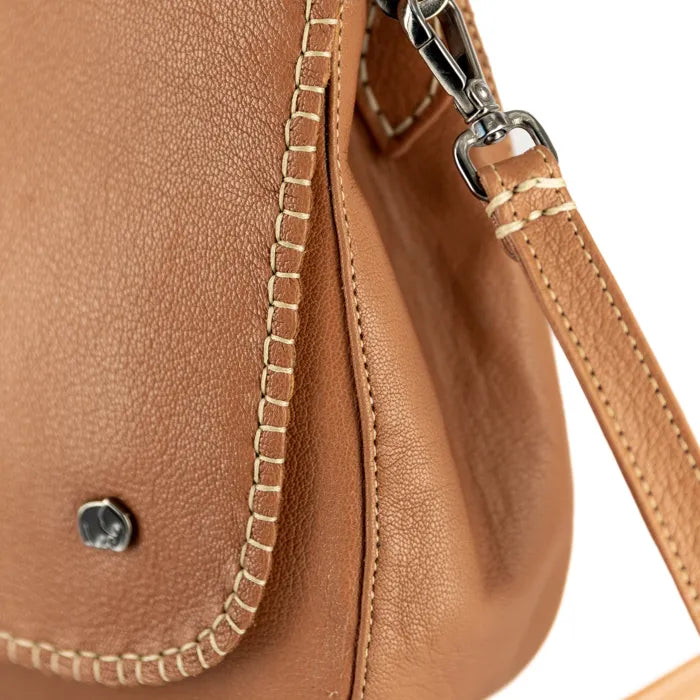 Close-up of a tan leather handbag with a strap on a white background