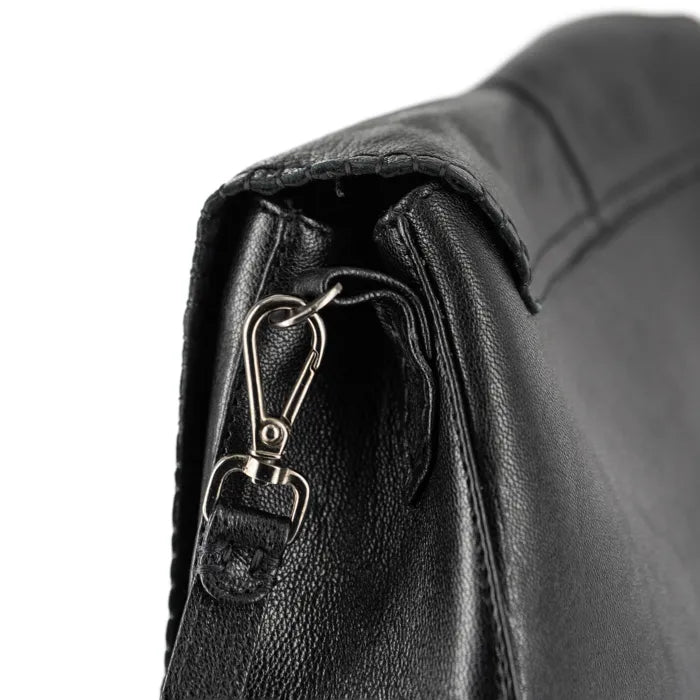 Close-up of a black leather bag with a metal clasp on a white background