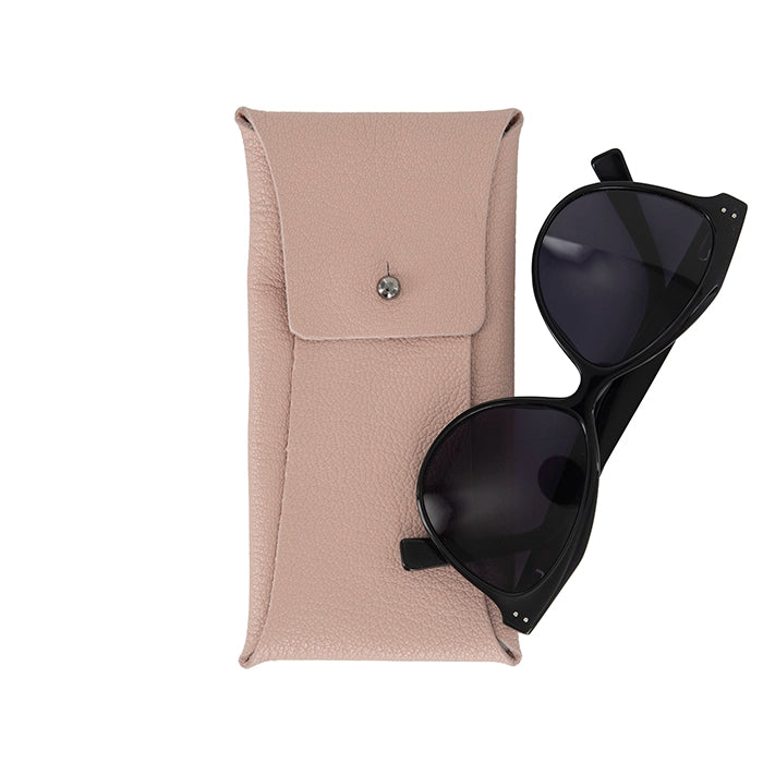 Black sunglasses on a pink leather case against a white background