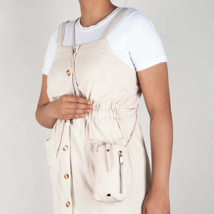 Beige cellphone pouch on a person on a plain background