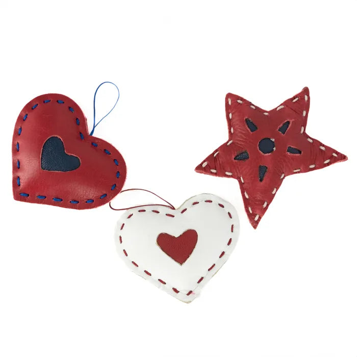 Three red and white heart-shaped ornaments on a white background