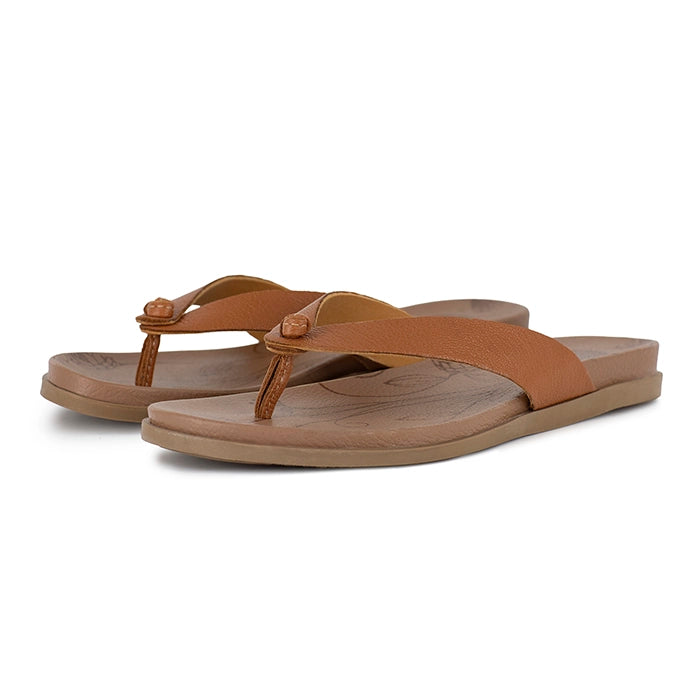 Pair of tan sandals on a white background
