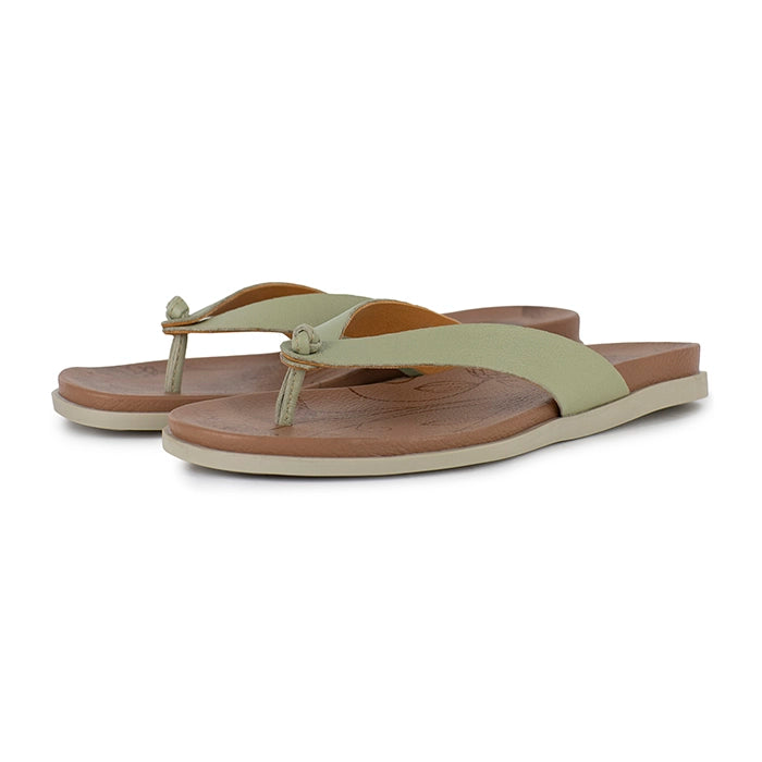 Pair of sandals with green straps and brown soles on a white background