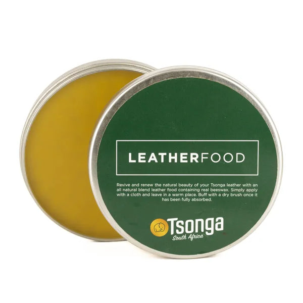 Green tin of Leatherfood with yellow interior on a white background