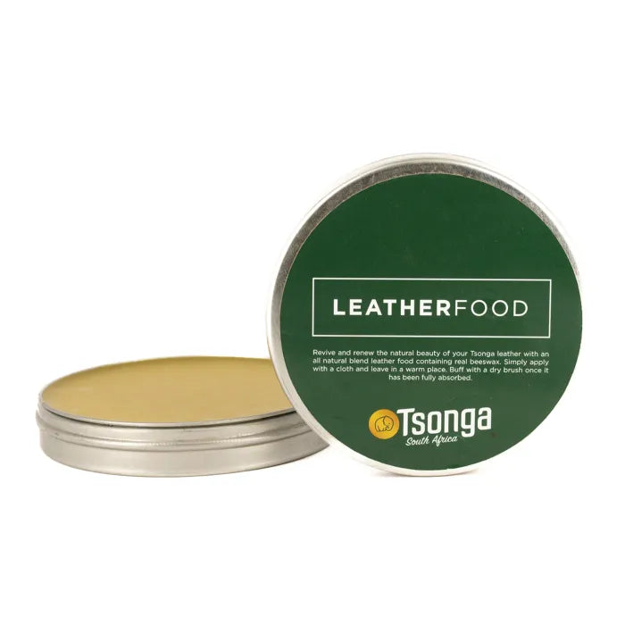 Tin of leather food with green lid and gold base on a white background