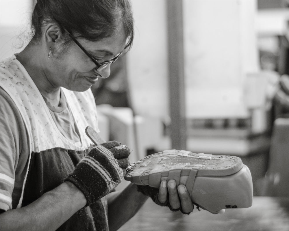 Assembling the shoes using water based adhesives to fix uppers to the soles