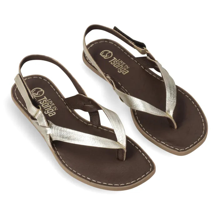 A pair of women's flat thong sandals with metallic silver crisscross straps and a dark brown footbed, shown on a white background.