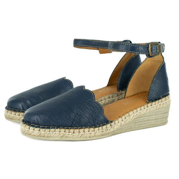 Pair of navy blue espadrille wedge sandals on a white background