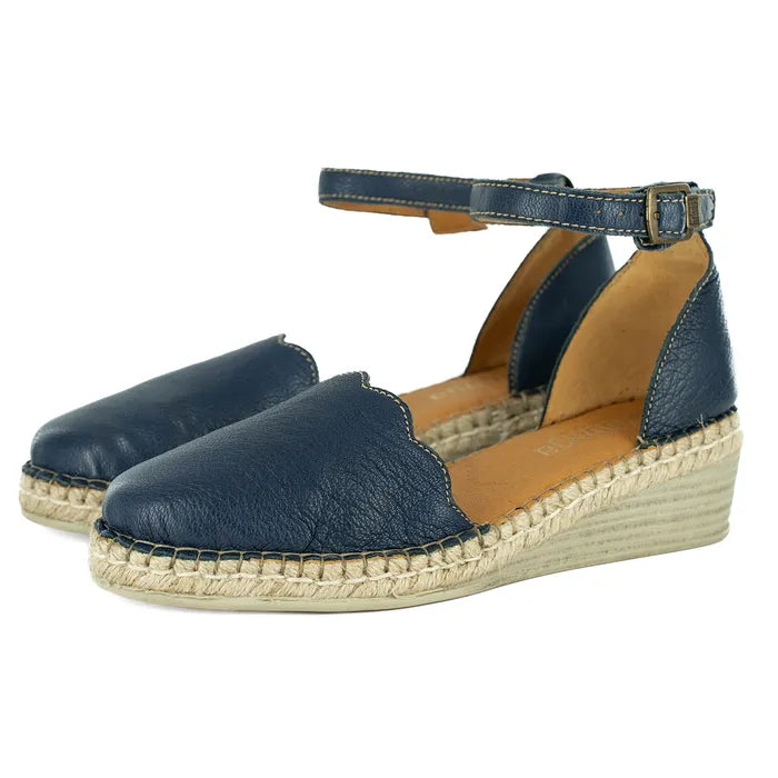 Pair of navy blue espadrille wedge sandals on a white background